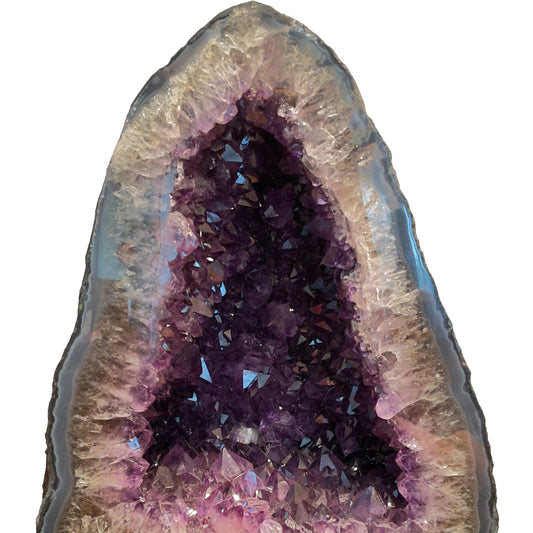 Explore the raw allure of amethyst with this image featuring a geode's deep purple heart, lavender edges, and a rugged gray exterior. Perfect for gem enthusiasts.